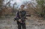 mA woman poses with her rifle in Nizhnaya Krinka