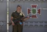 A woman poses with her rifle in Donetsk